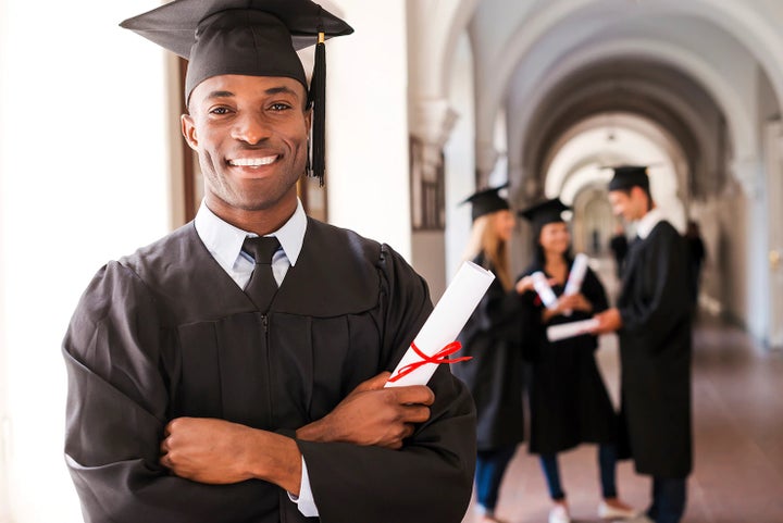 college graduate holding his diploma | Flow Subaru of Charlottesville in Charlottesville VA